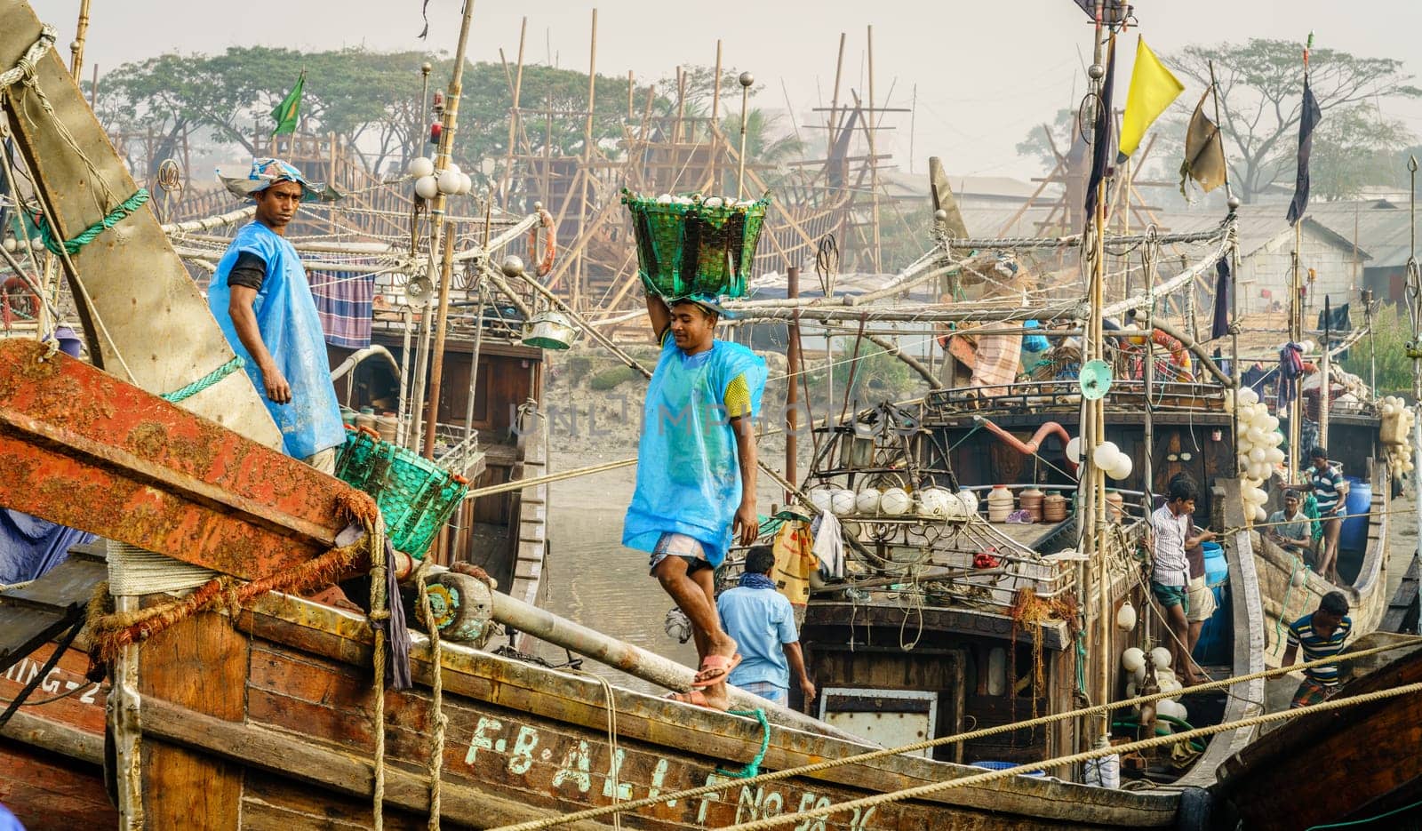 Chittagong, Bangladesh, December 23, 2017: Fishermen bringing fresh catch from the boat at the port on the Karnaphuli River in Chittagong