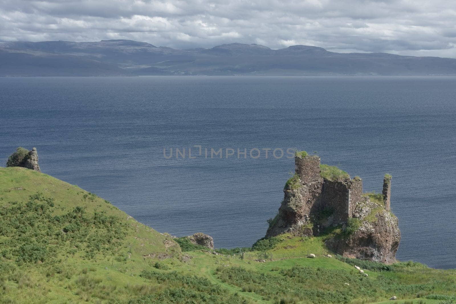 Old ruined coastal castle, brochel castle, on the shores of the inner sound and isle of Raasay in scotland. Sunny day with a cloudy sky.