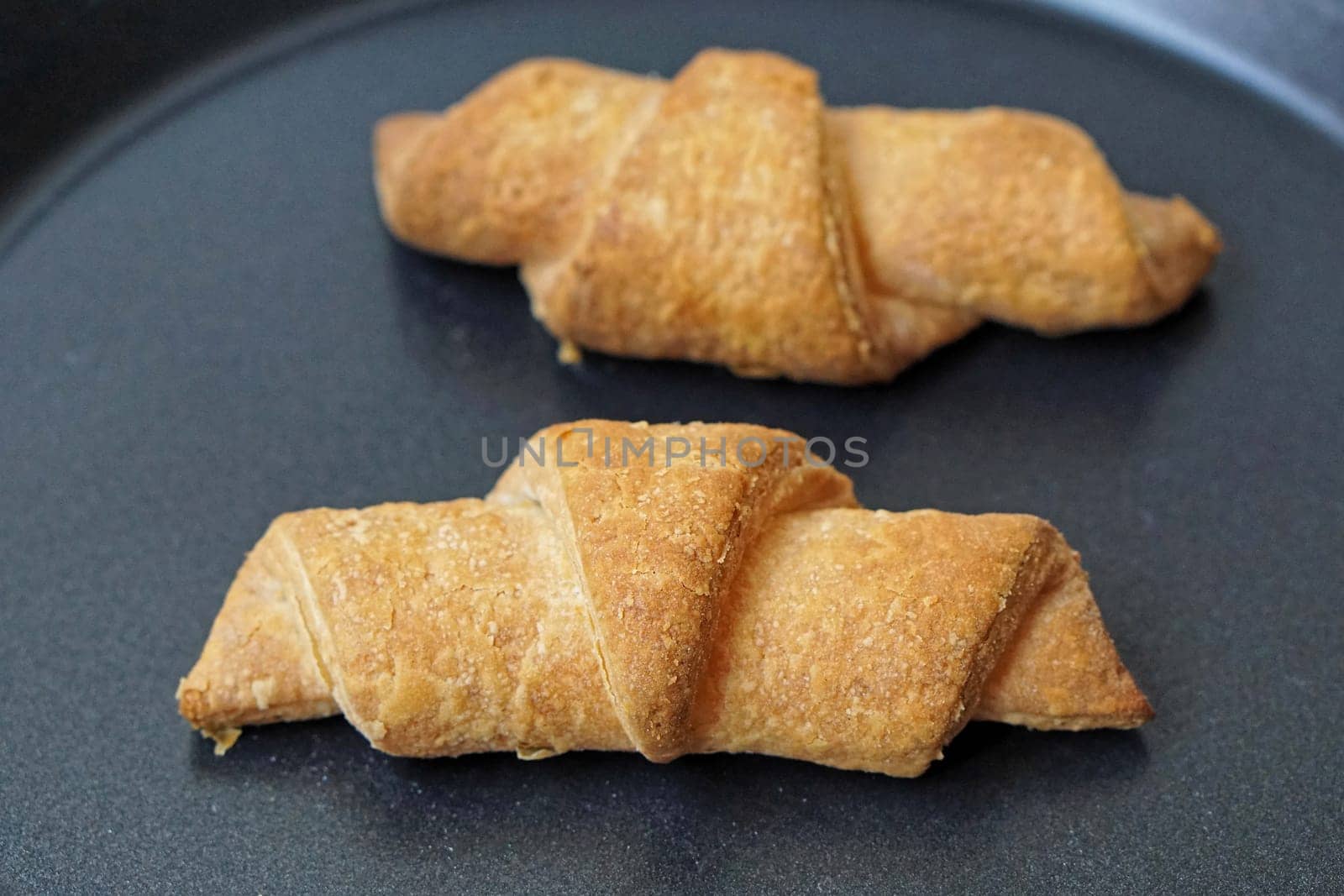 Two croissants french pastry at tray