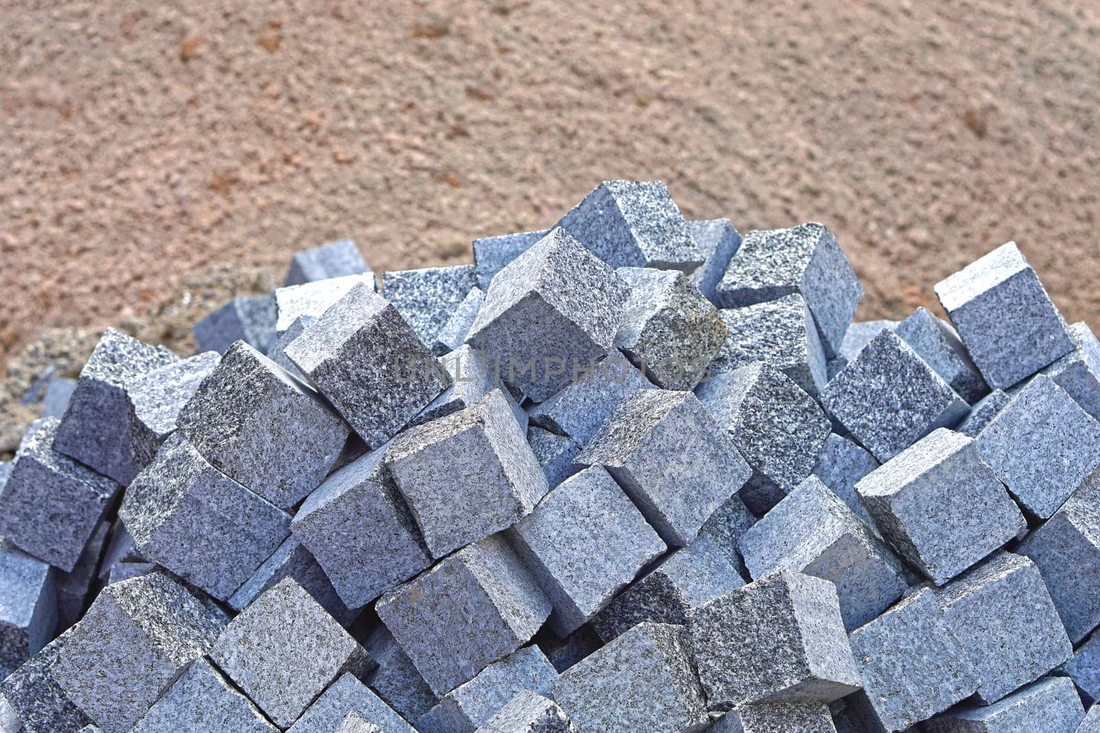 Big bunch of cobblestone bricks at construction site