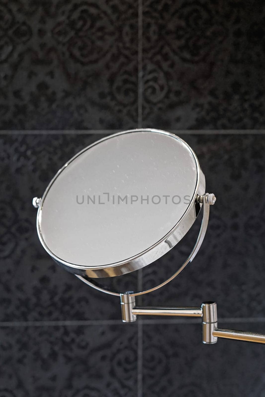 Double sided beauty makeup mirror at wall in bathroom