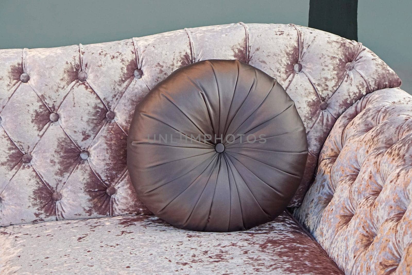 Round leather pillow at upholster sofa