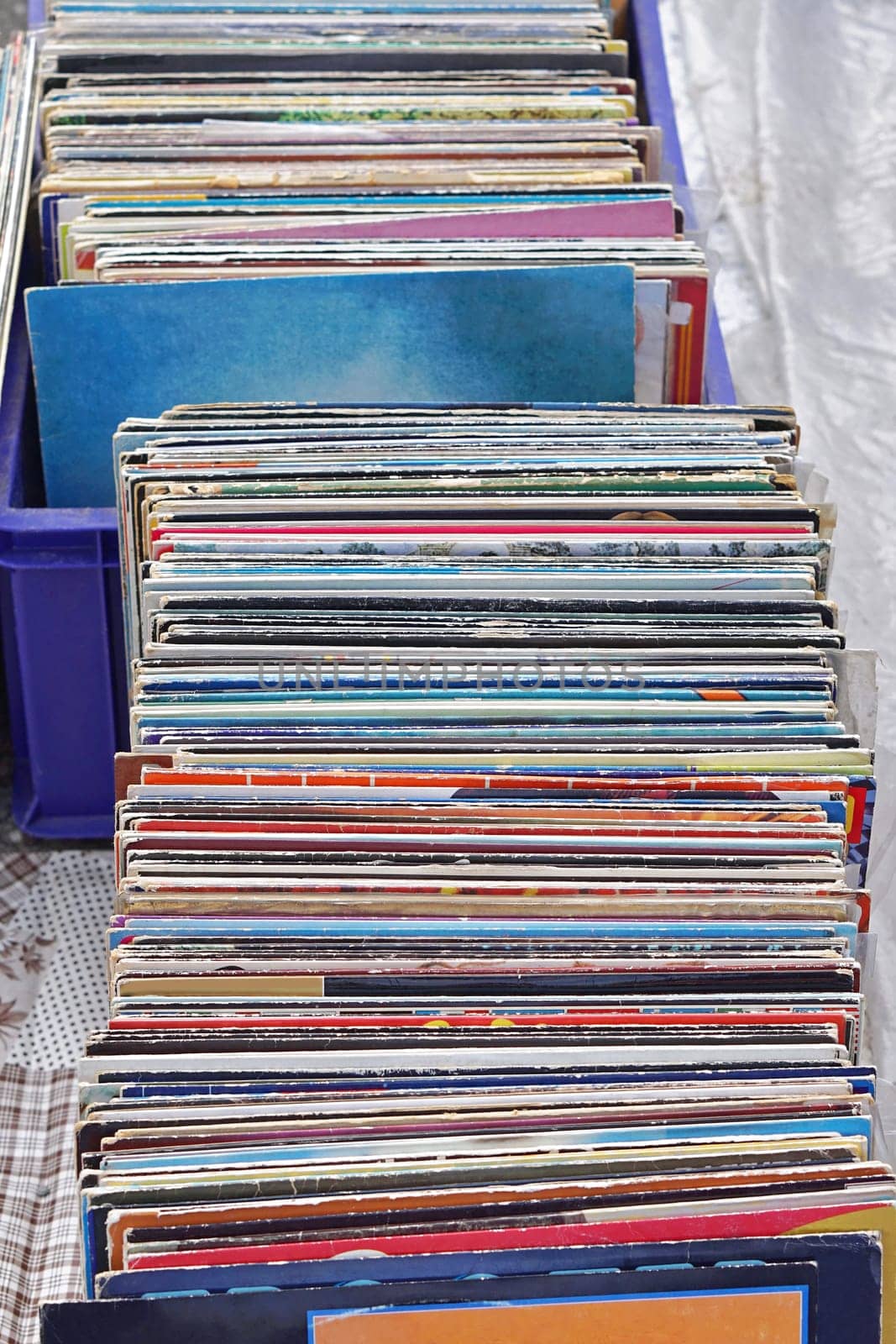 Stacked second hand vinyl records at flea market