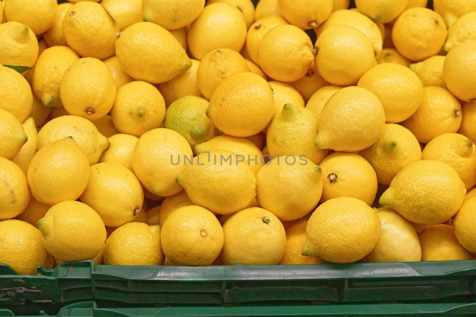 Big bunch of yellow lemons in crate