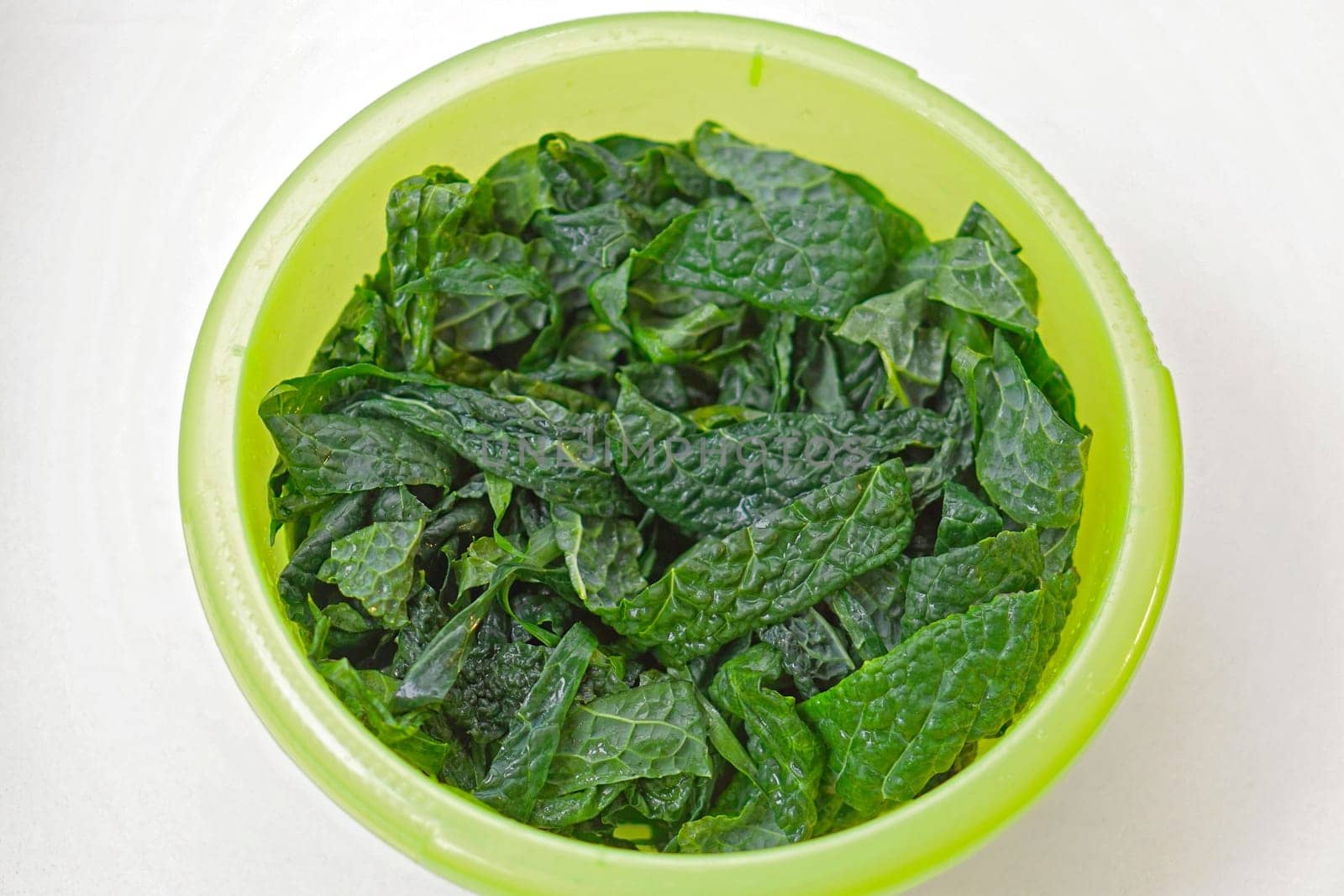 Big green bowl of fresh kale salad