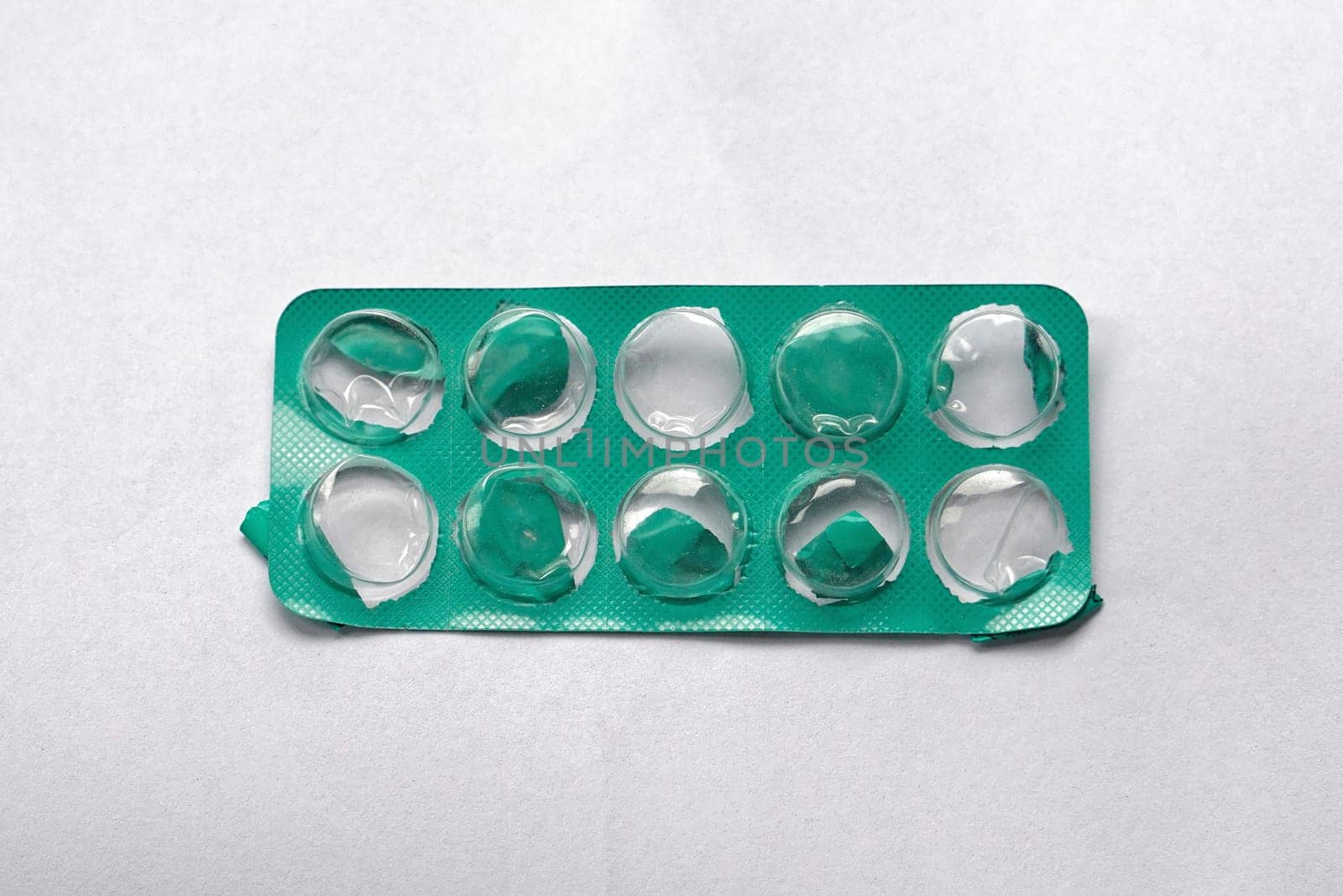 Empty green tablet foil blister pack