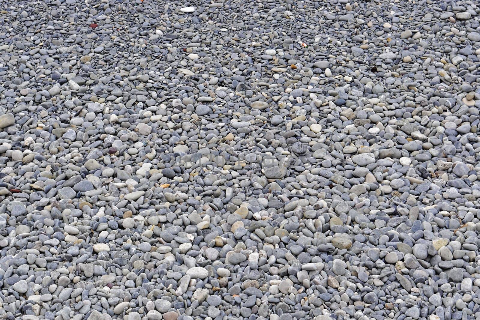 Big pebbles at beach texture background