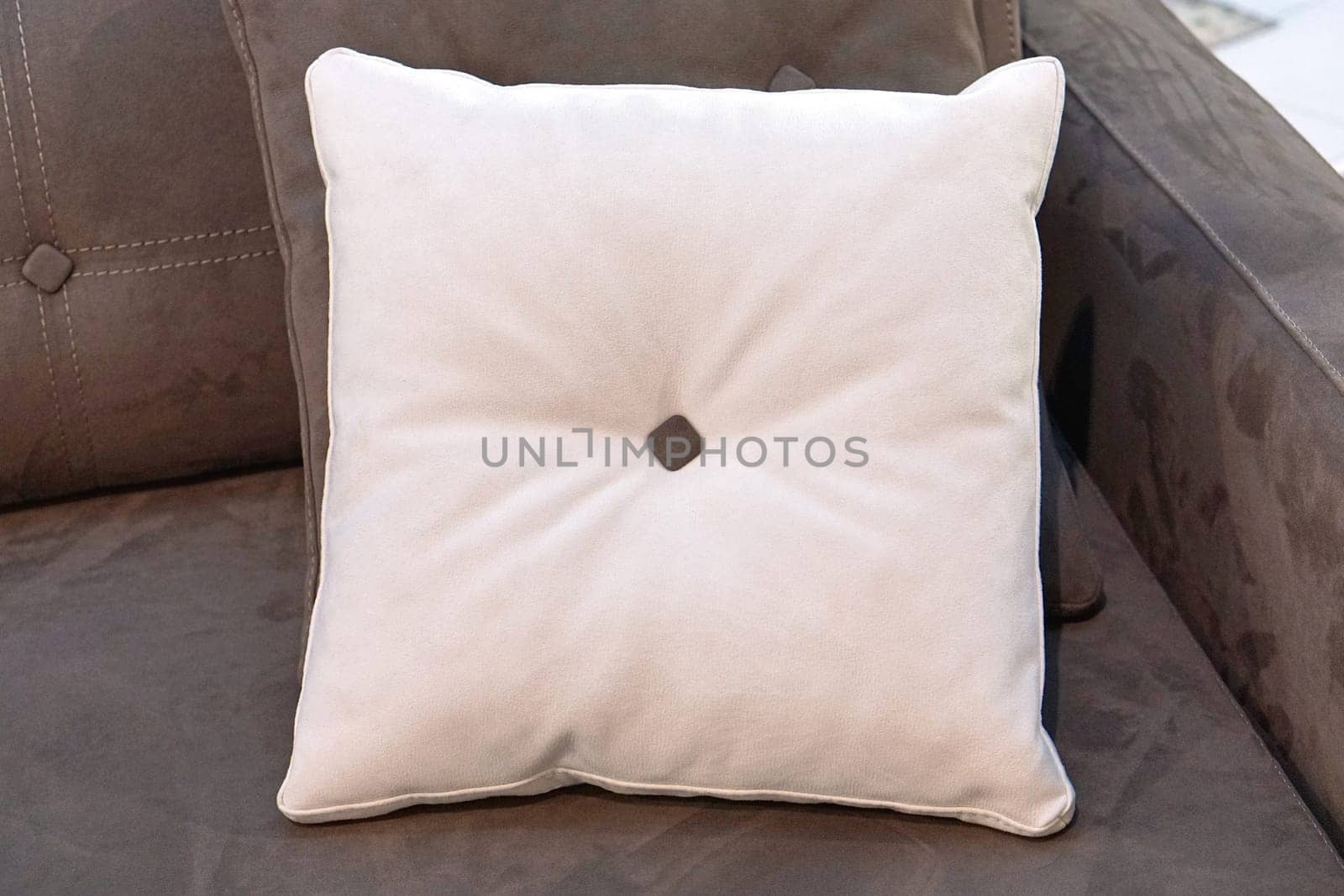 Decorative white pillow at sofa