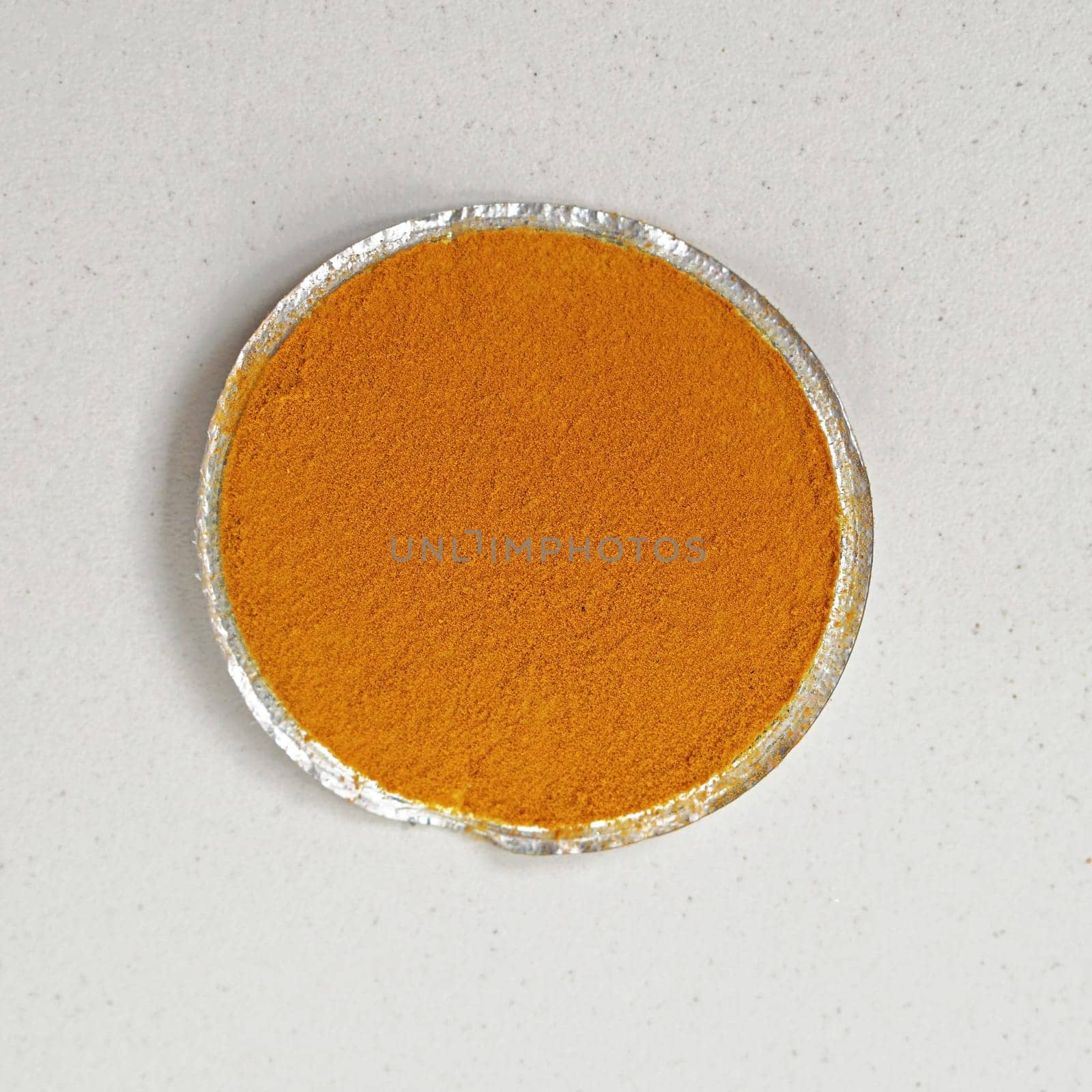 Tumeric spice in small round package