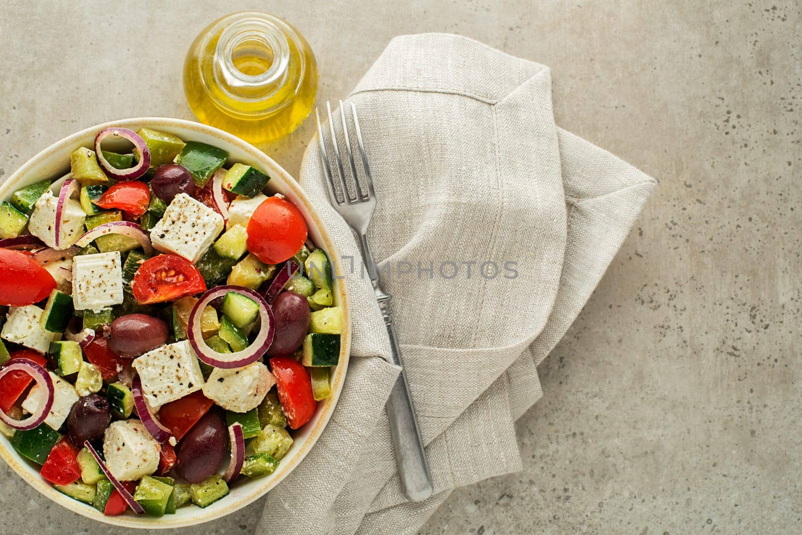 Healthy Salad with feta cheese and fresh vegetables on grey background. Greek salad.