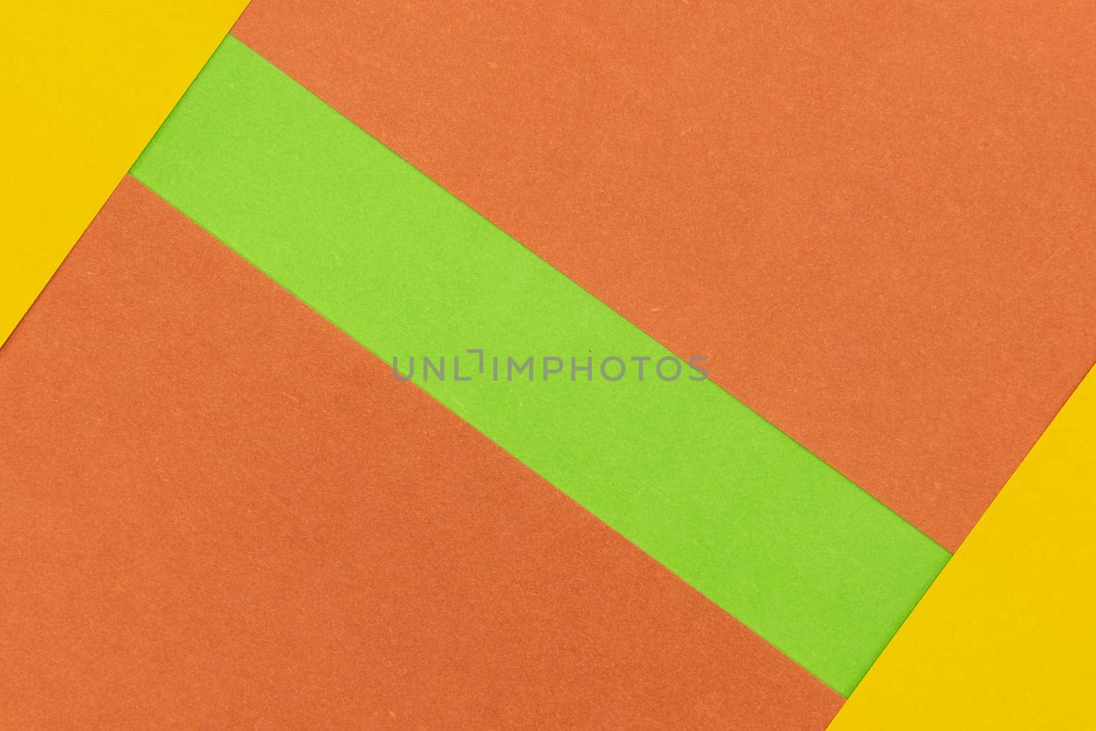 Green, Orange and Yellow coloured paper background, abstract contrast conceptual image