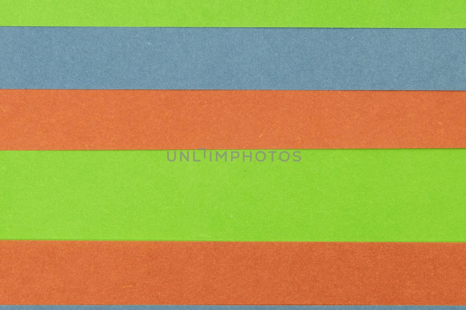 Green, Orange and Blue coloured paper background, abstract contrast conceptual image