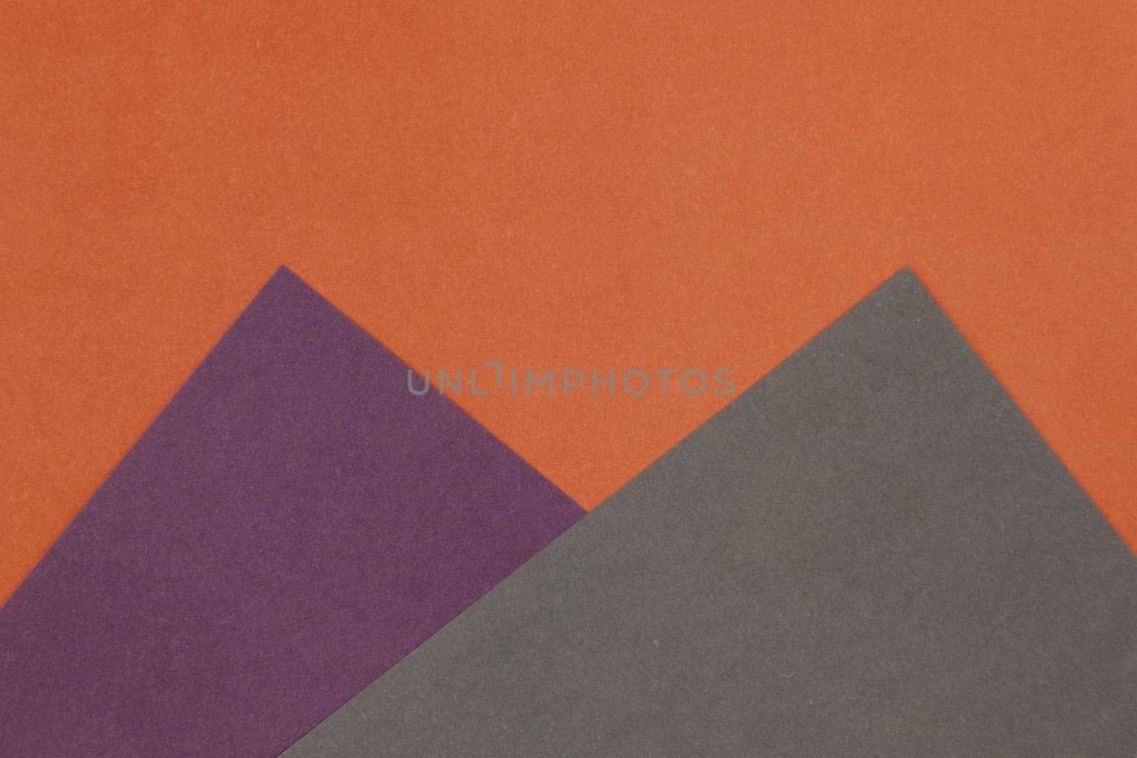 Grey, Purple and Orange coloured paper background, abstract contrast conceptual image