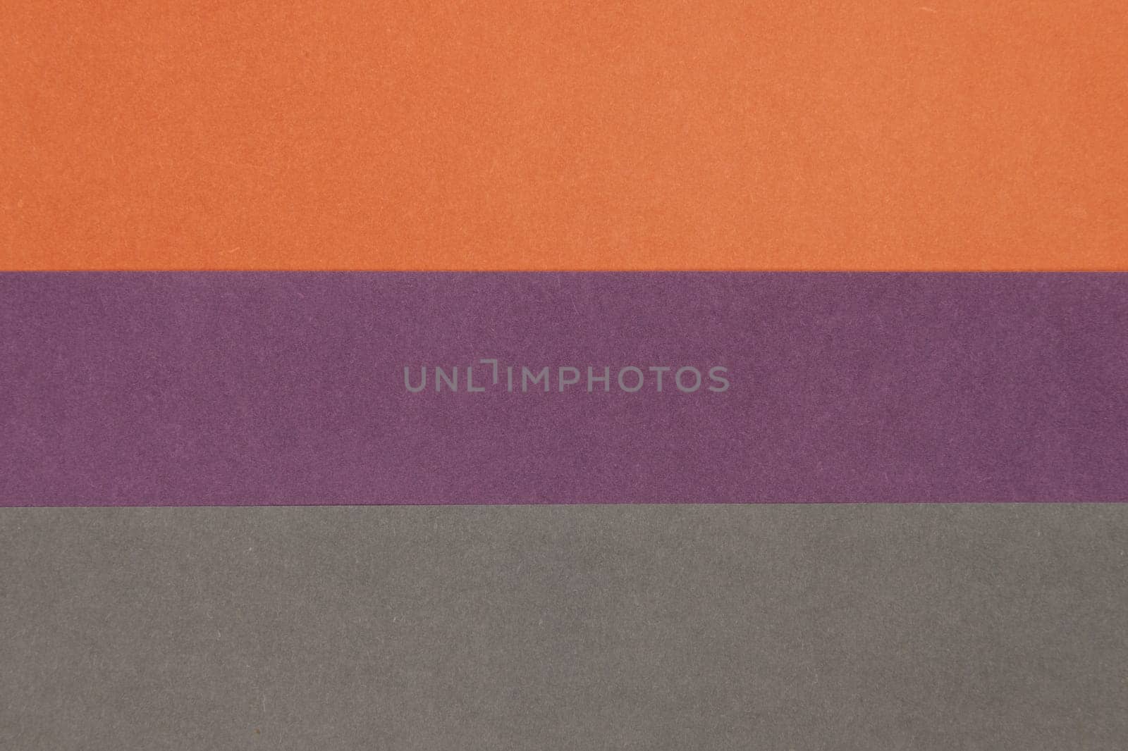 Grey, Purple and Orange coloured paper background, abstract contrast conceptual image