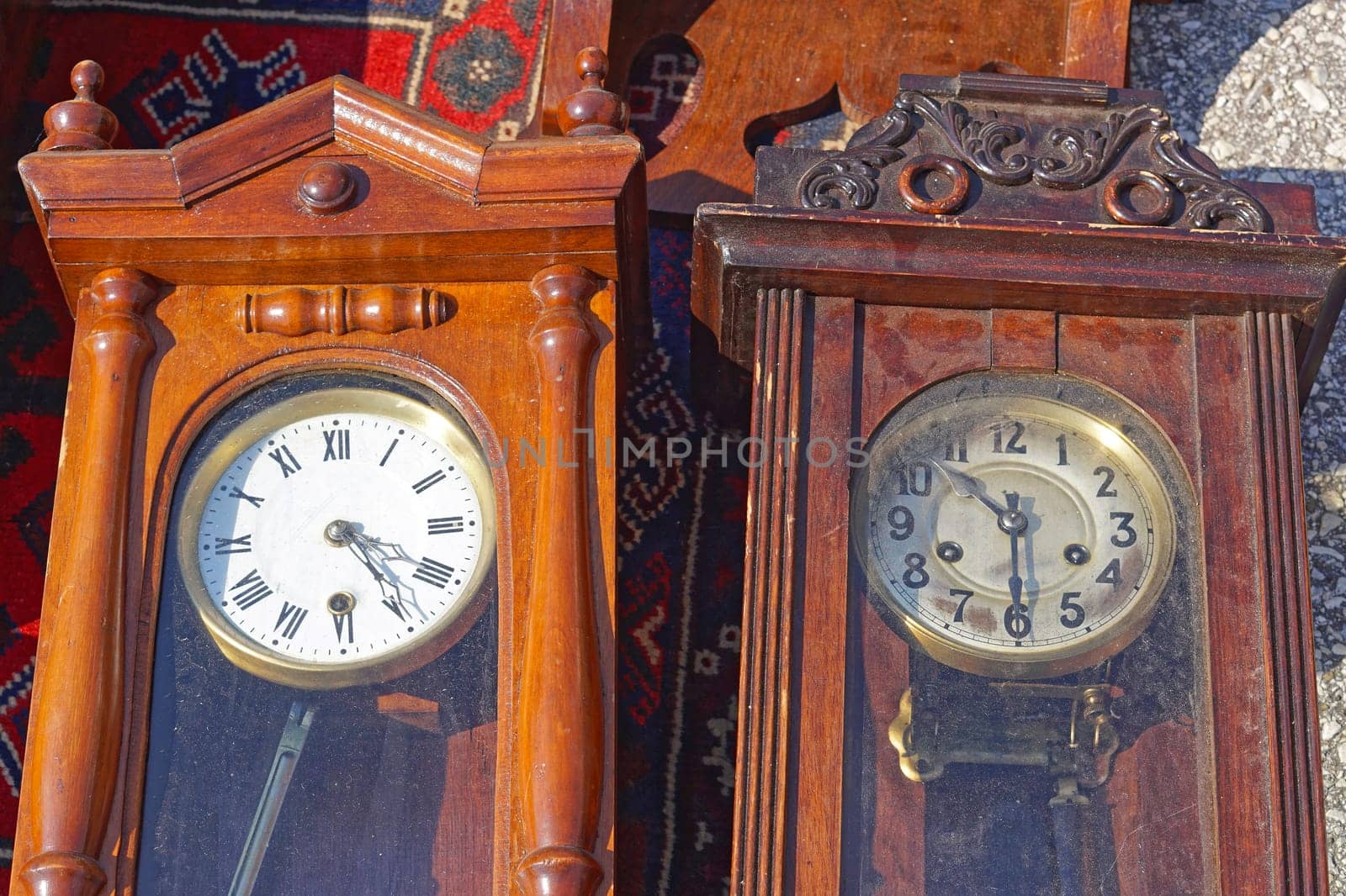 Two wooden grandfather clocks with pendulum at flea market