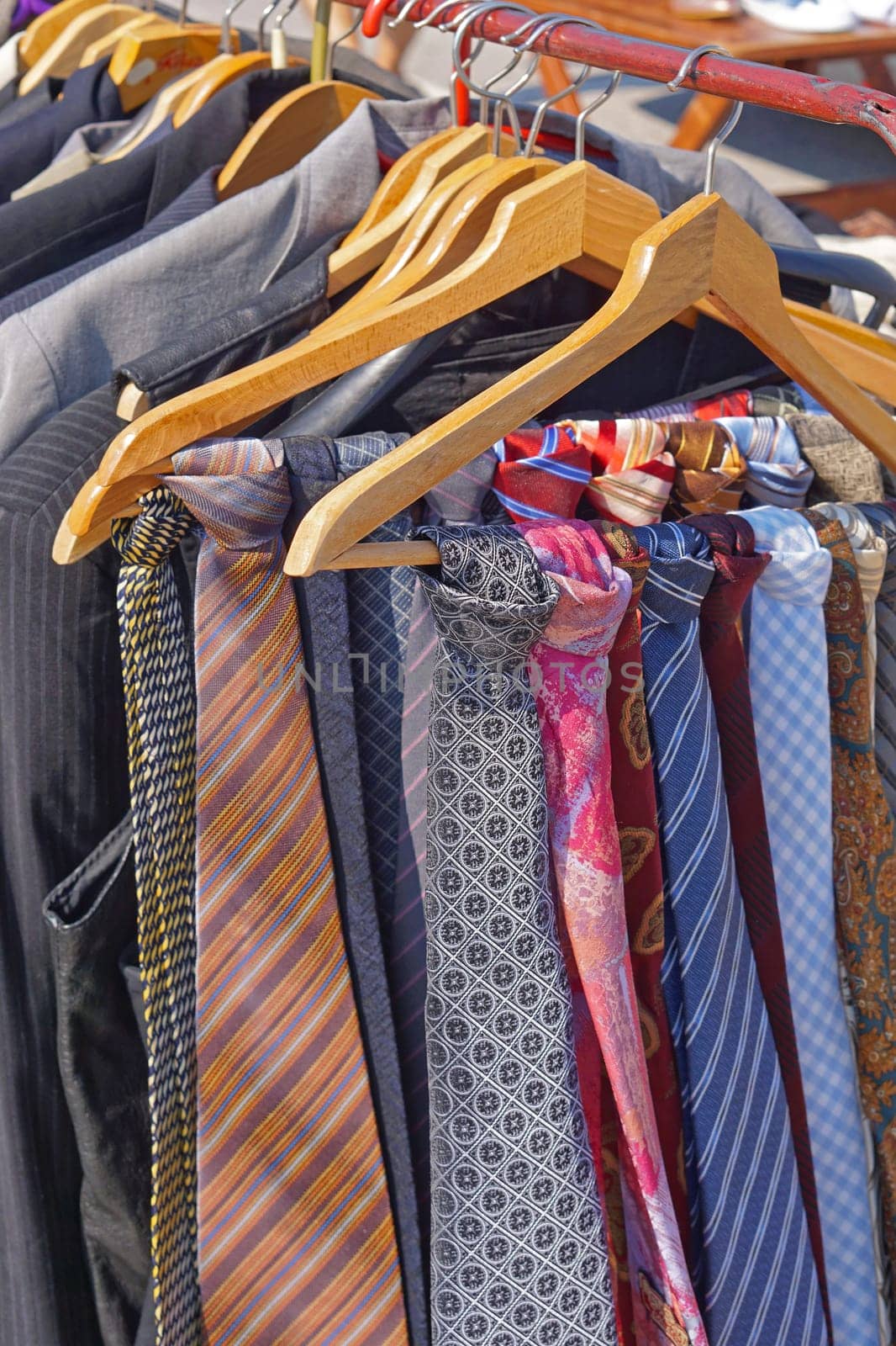 Colourful silk neck ties assortment at coat hangers