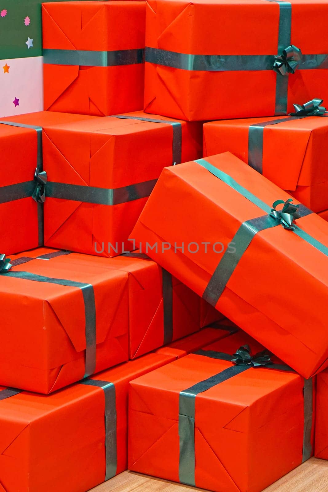 Big pile of red gifts with green ribbon
