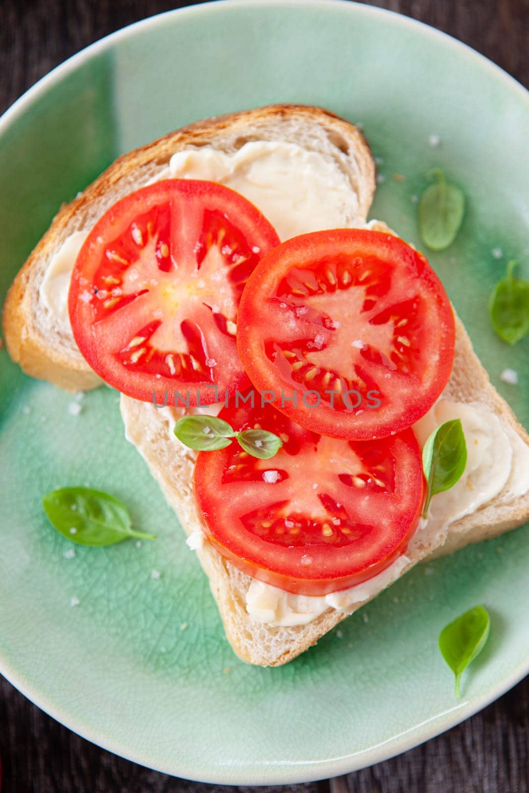 Open sandwich with fresh vine tomatoes and basil