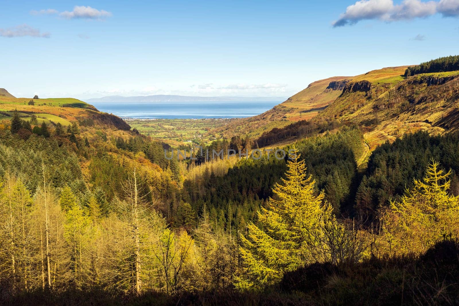 Panoramic view on the valley of Glenariff Forest Park in autumn colours with Scotland shore in far distance, Count Antrim, Northern Ireland