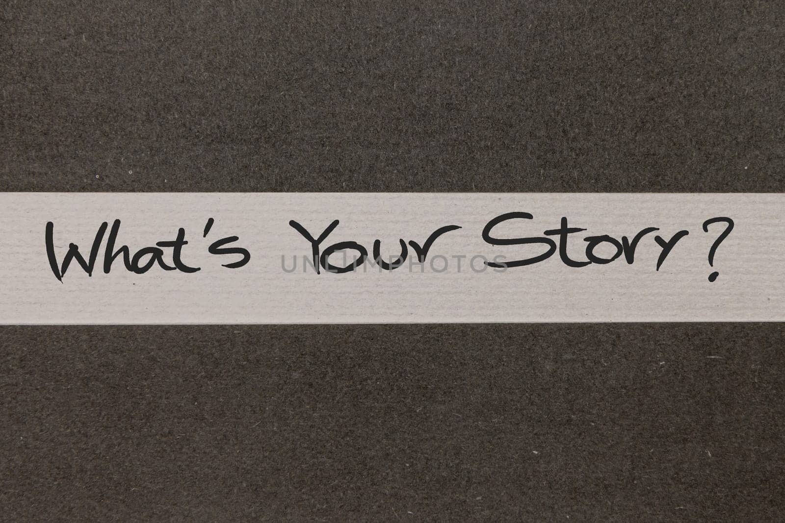 White and Grey coloured paper background with Whats Your Story motivational handwritten message