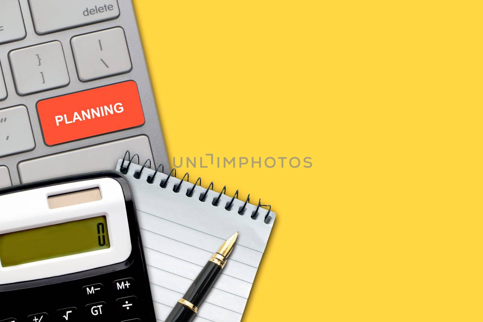 Flat lay, top view office table desk. PLANNING text with pen, calculator, notepad and keyboard on the yellow background. Business Finance, Education and Copy Space concept