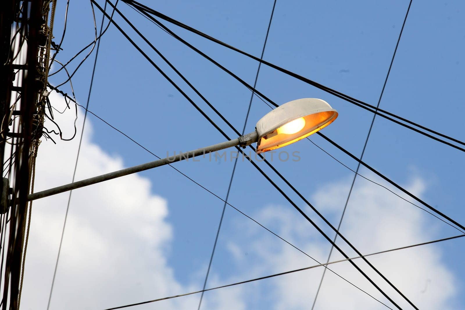 itabuna, bahia / brazil - april 13, 2012: street lamp post is seen lit during the day in the city of Itabuna.
