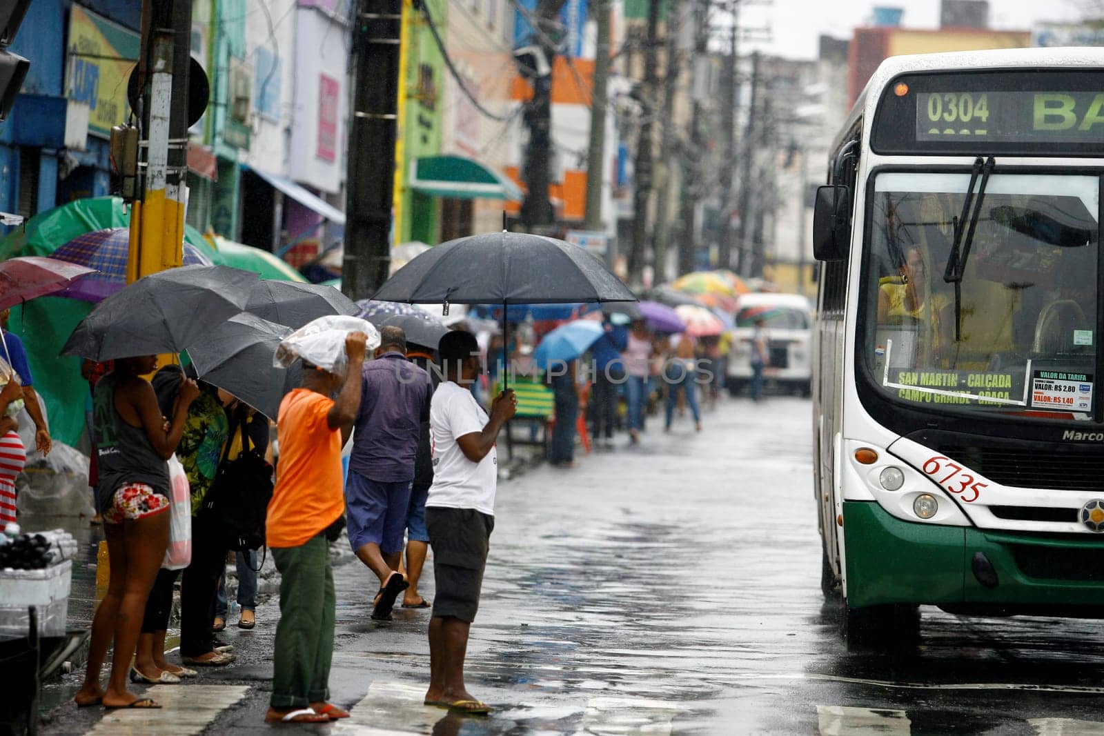 salvador, bahia / brazil - august 26, 2016: People are seen using umbrella during rain in the city of Salvador.