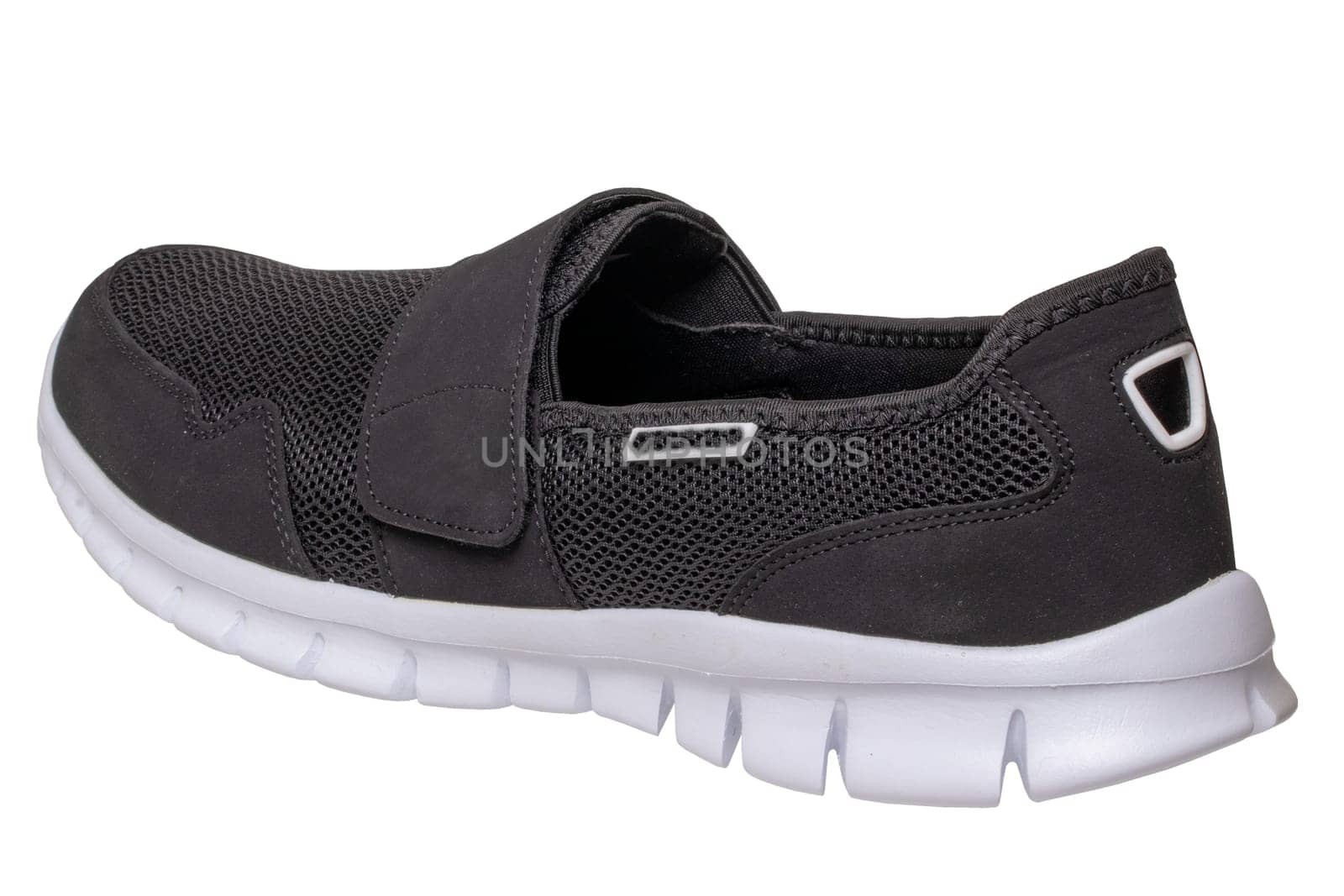 Mans black shoes. Close-up of a single black sneaker or sport shoe isolated on a white background. Elegant and trendy mens footwear. Macro.