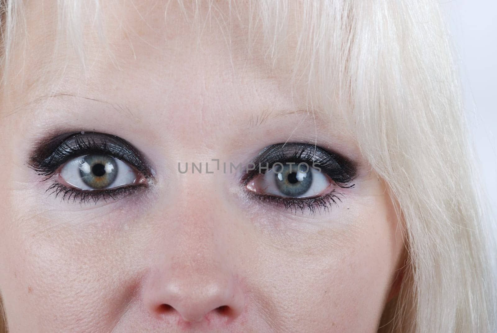 Close up the eyes of a young blond woman