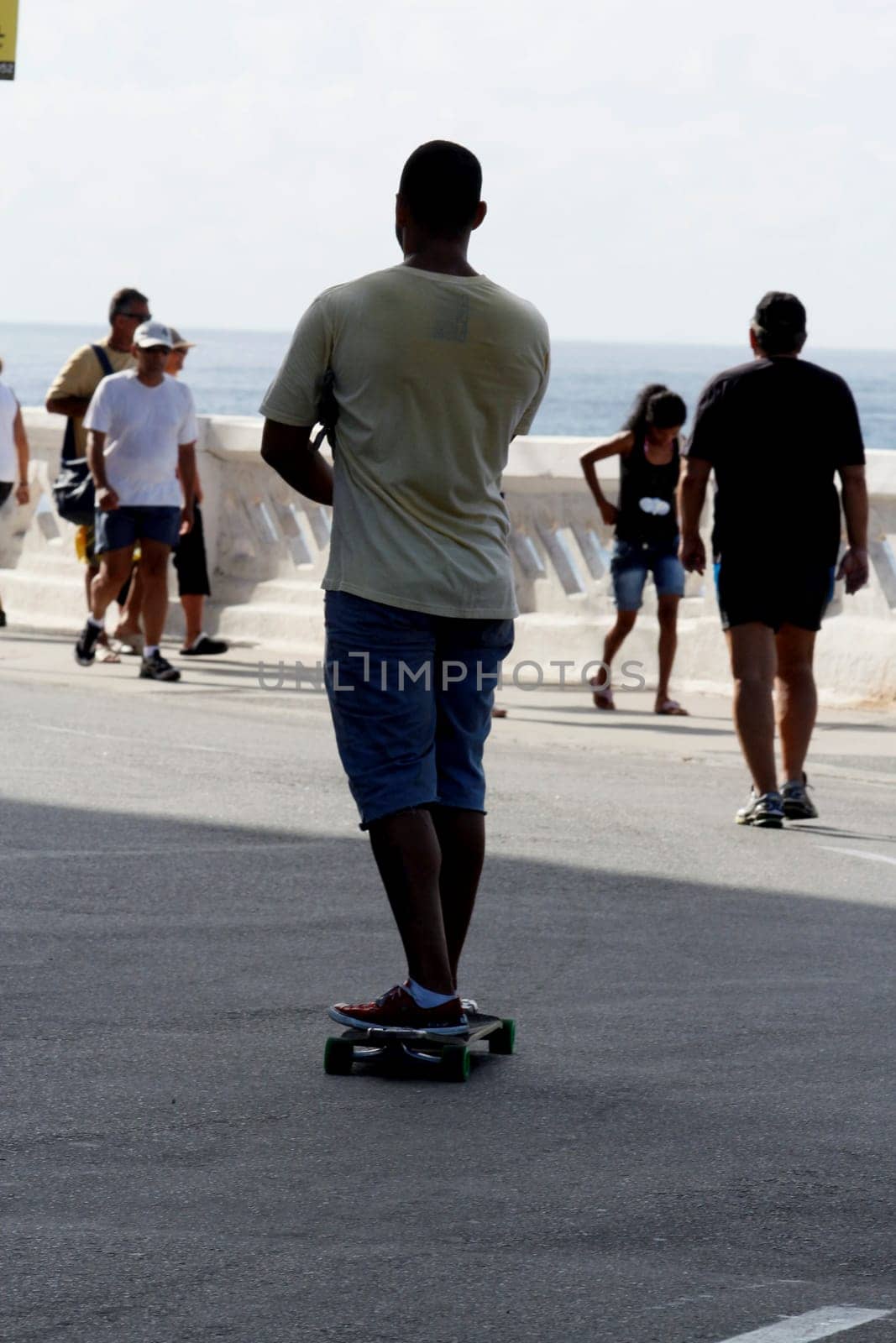 salvador, bahia / brazil - april 14, 2013: person is seen skateboarding on the street in the city of Salvador.