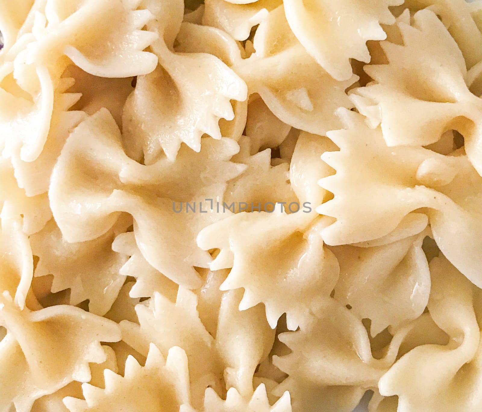 Close up of farfalle pasta background. Farfalle are a type of pasta/noodle commonly known as bow-tie pasta or butterfly pasta.