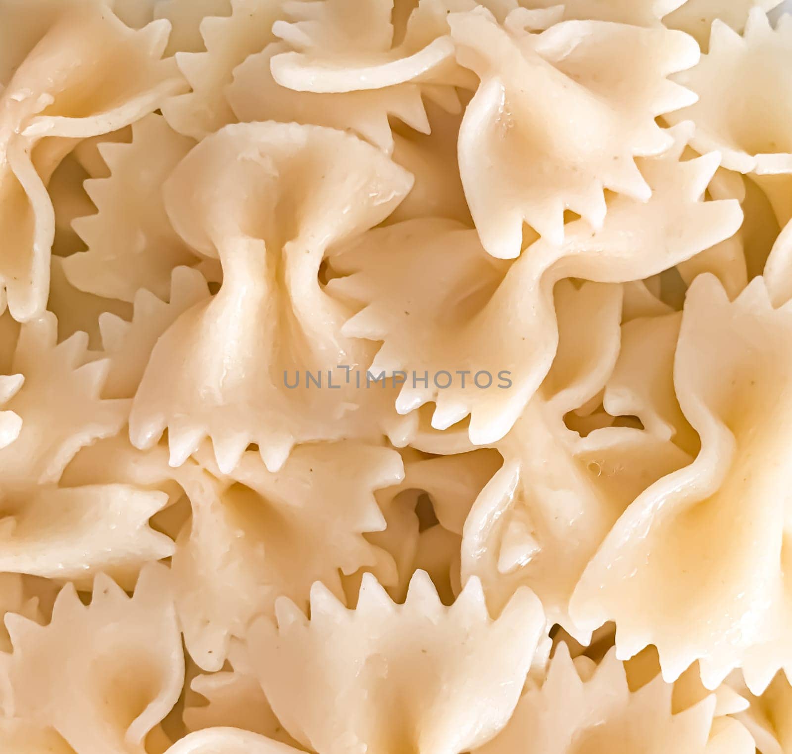 Close up of farfalle pasta background. Farfalle are a type of pasta/noodle commonly known as bow-tie pasta or butterfly pasta.