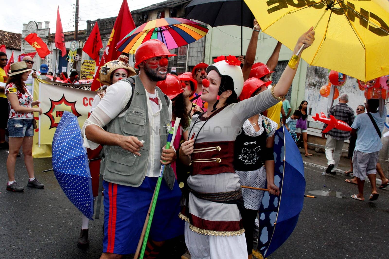 salvador, bahia / brazil - july 2, 2013: people wearing clown costumes protest during the Bahia independence parade in the city of Salvador.