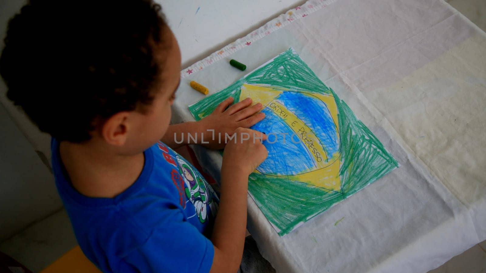salvador, bahia / brazil - september 3, 2020: child paints pabeira do Brasil with crayons at his home in the city of Salvador.
