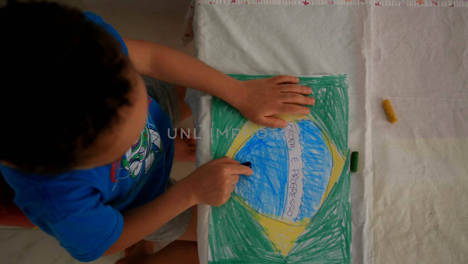 salvador, bahia / brazil - september 3, 2020: child paints pabeira do Brasil with crayons at his home in the city of Salvador.