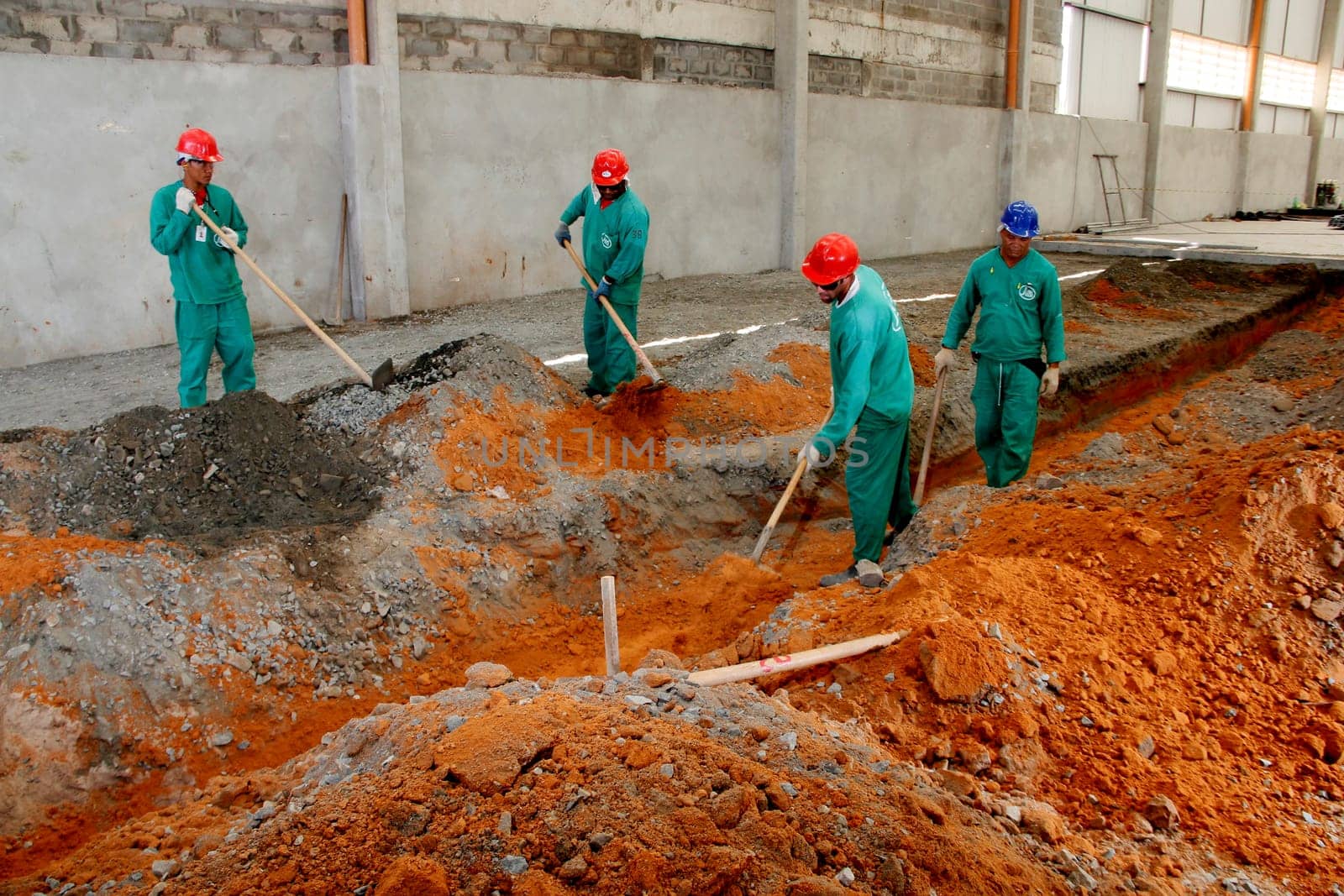 sao sebastiao do passe, bahia / brazil - september 4, 2013: workers are seen during construction of street paving in the city of Sao Sebastiao do Passe..