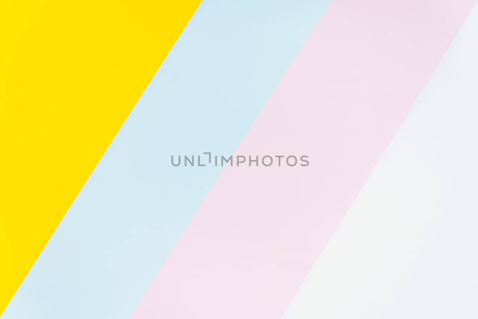 Minimalist abstract background featuring diagonal stripes in yellow, blue, pink, and white. Modern and soft color composition, ideal for design, branding, or artistic projects