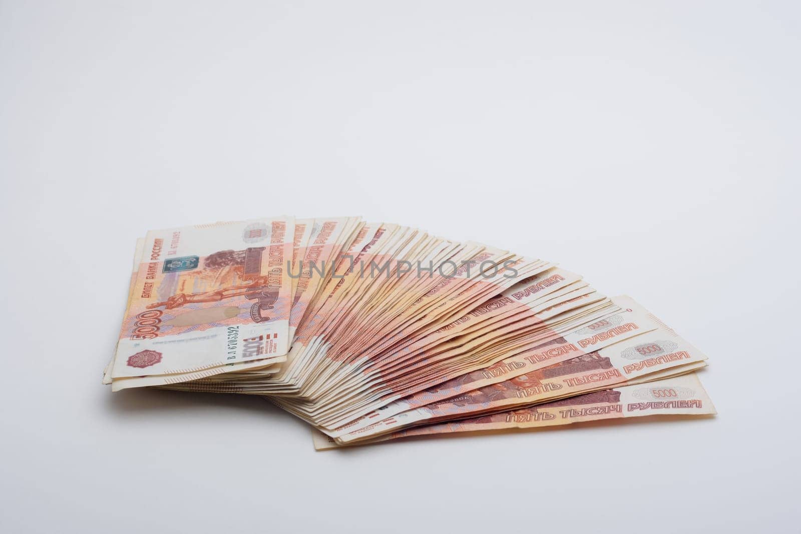 on a gray background lies a fanned pack of five thousandth Russian banknotes