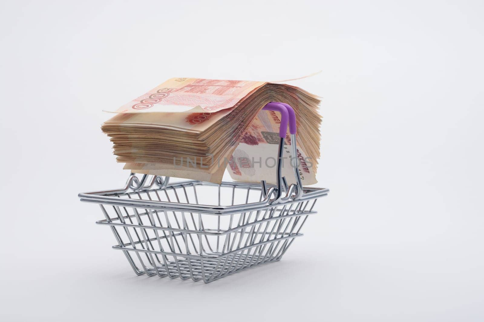 On the handles of the grocery basket is a large bundle of paper Russian five-thousandth bills