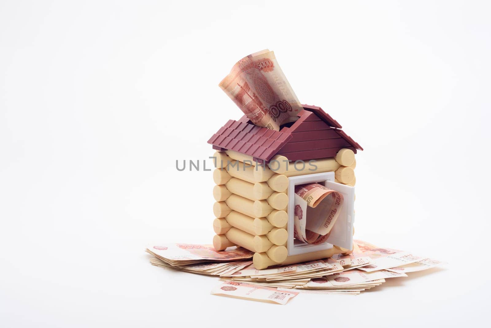 Five-thousandth Russian banknotes stick out from the windows and the door of the house, the house stands on a bundle of banknotes