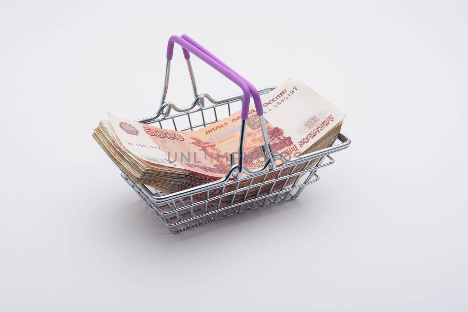 A large bundle of Russian bills is in the grocery basket