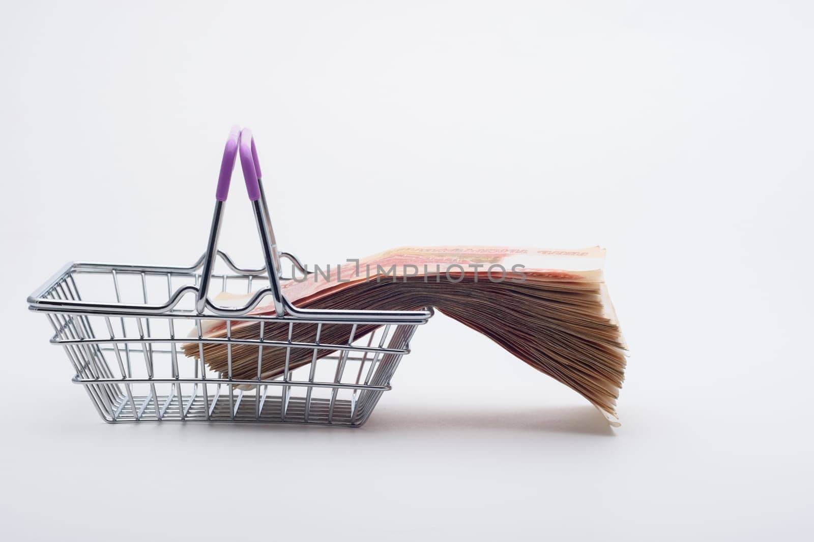 There is a large stack of bills on the grocery basket