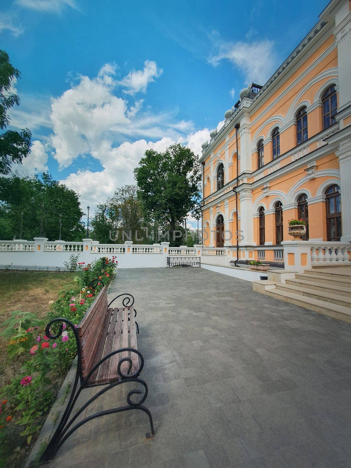 The yard with garden and benches in front of the Manuc Bei mansion. Manuc Bey manor, architectural, culture, historic complex with museum, winery and other edifices located in Hincesti city, Moldova.