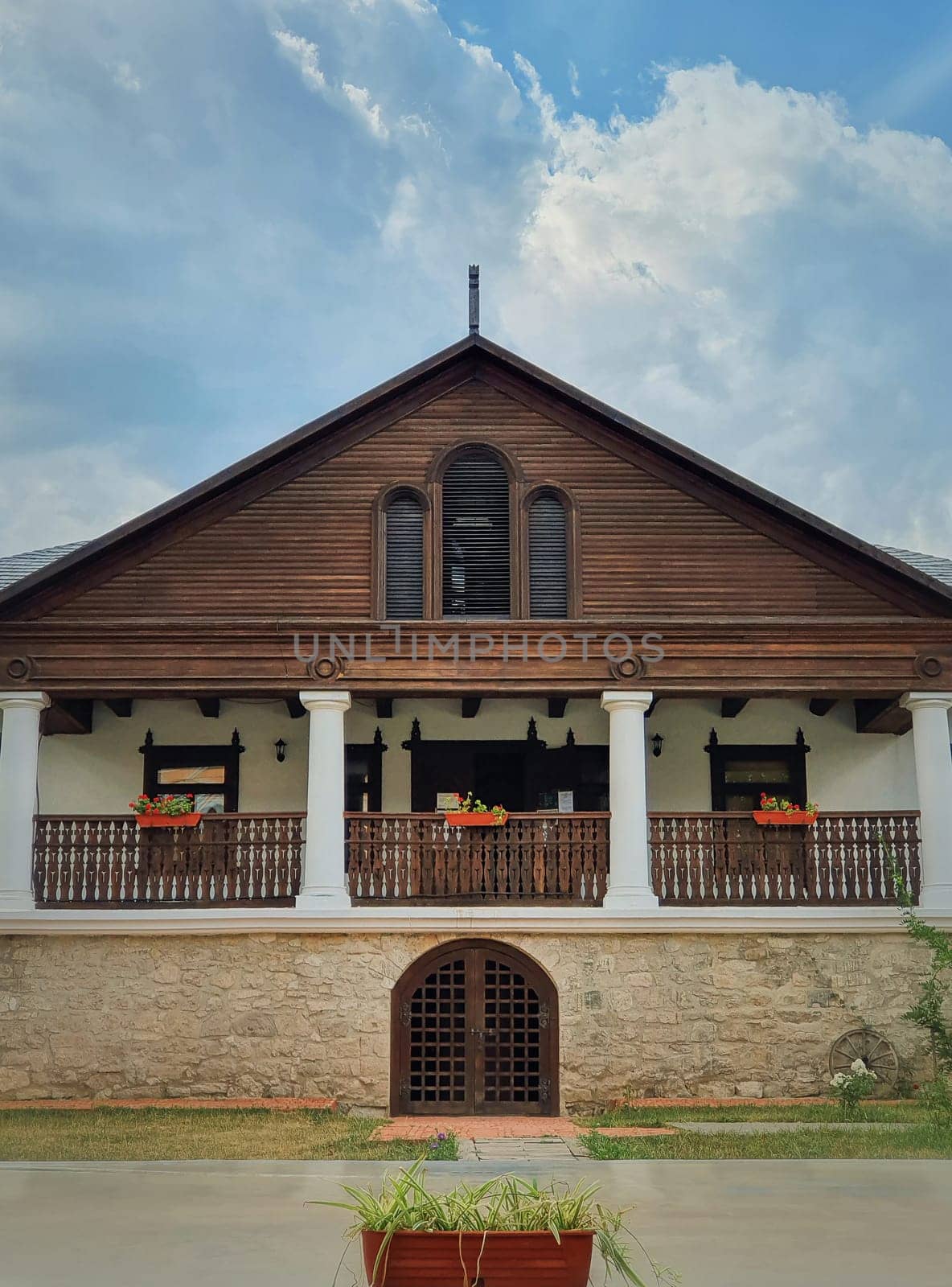 The Museum house facade at Manuc Bei mansion, architectural, culture and historic complex of Hincesti city, Moldova. Old, traditional moldavian rural home with porch on pillars, stone and wood details