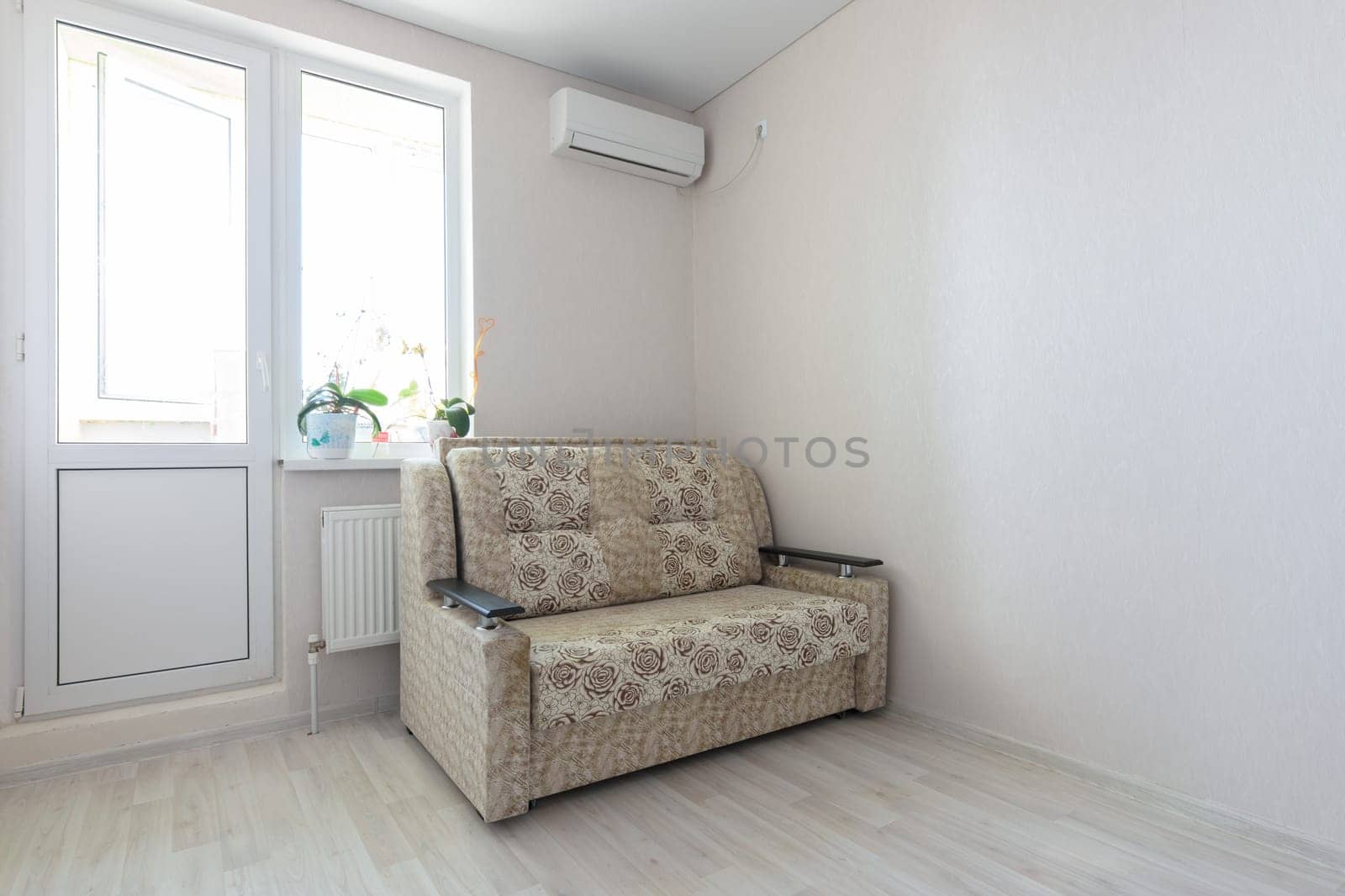 View of part of the room at the exit to the balcony, sofa and air conditioning