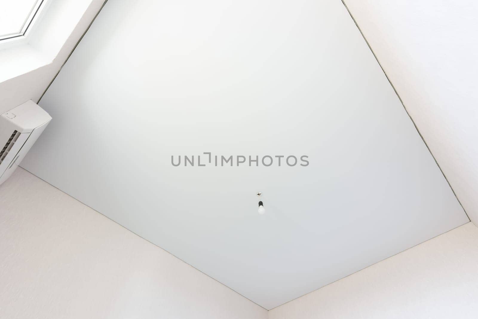 Stretch white ceiling in a rectangular room