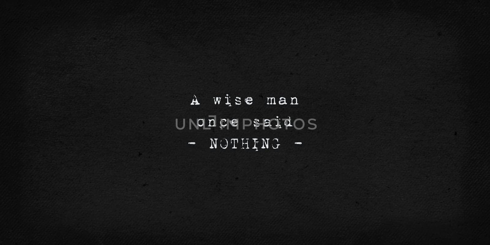 A wise man once said nothing. Powerful and dramatic quote. Text art illustration, typewriter font on old black paper background. Inspirational and motivational words, minimalist lettering composition.