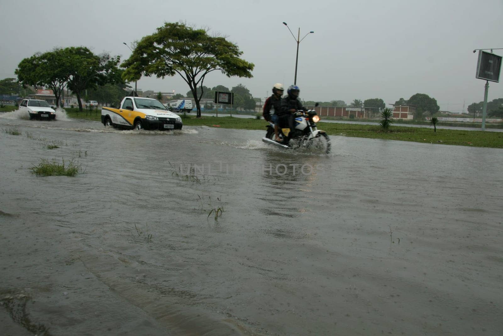 eunapolis, bahia / brazil - april 9, 2009: vehicle transits in flooded area on highway BR 101 in the city of Eunapolis, in southern Bahia..