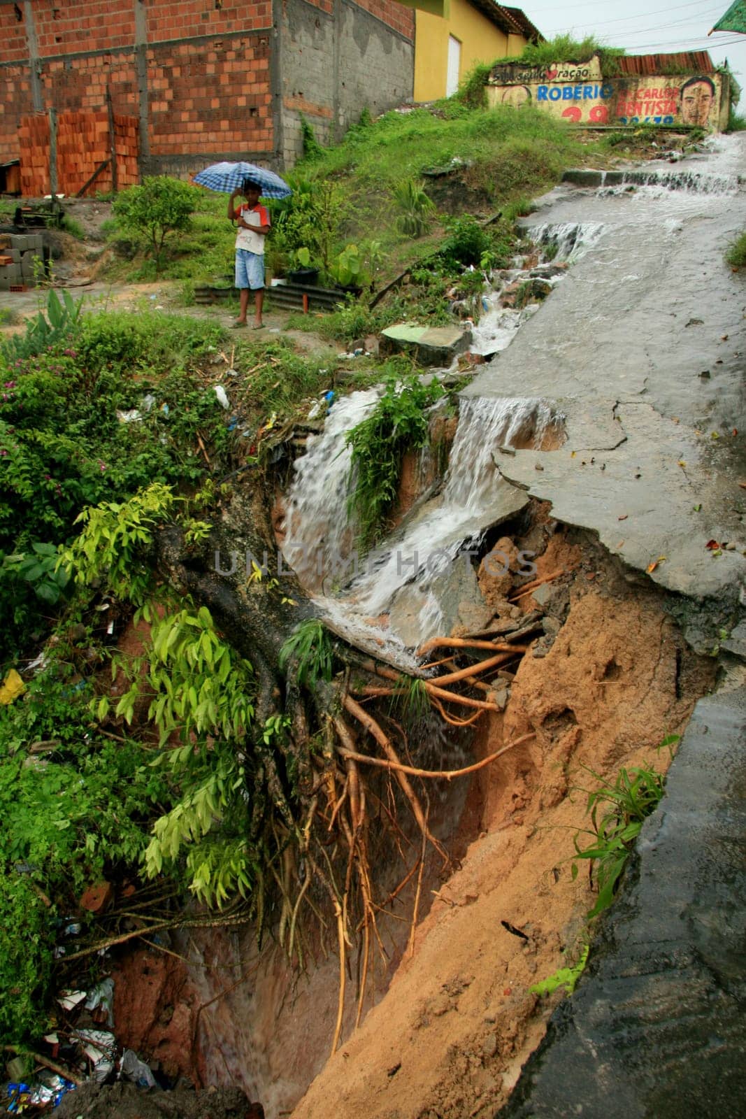 eunapolis, bahia / brazil - april 9, 2009: crater caused by soil erosion is seen on the street in the city of Eupolis, in southern Bahia.