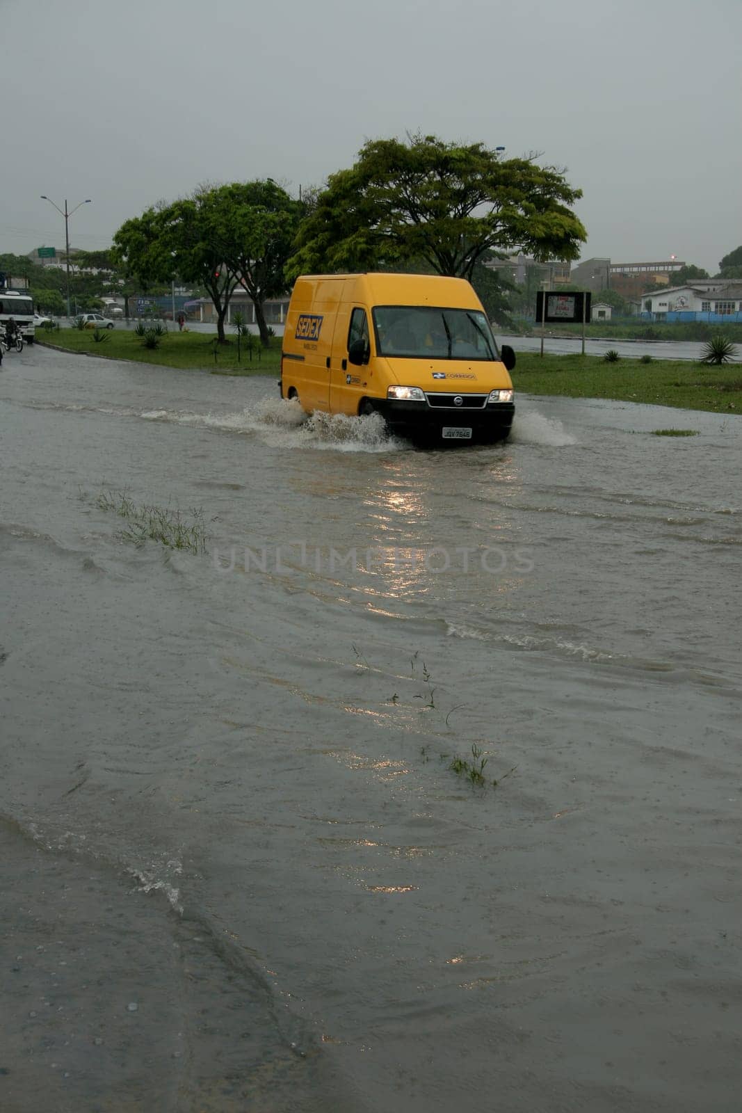 eunapolis, bahia / brazil - april 9, 2009: vehicle transits in flooded area on highway BR 101 in the city of Eunapolis, in southern Bahia..
